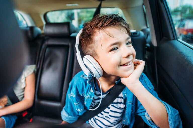 kid in car with headphones-audiobooks for kids