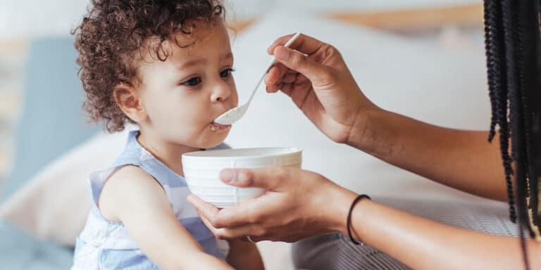 mom feeding baby, who is a picky toddler