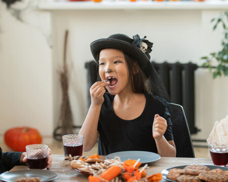 kids on halloween eating candy