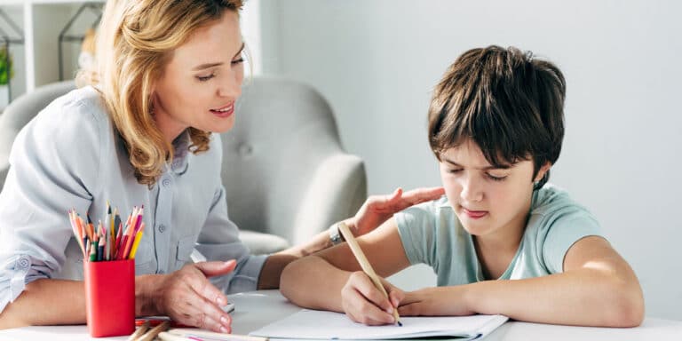 mom parenting a child with autism helping do homework