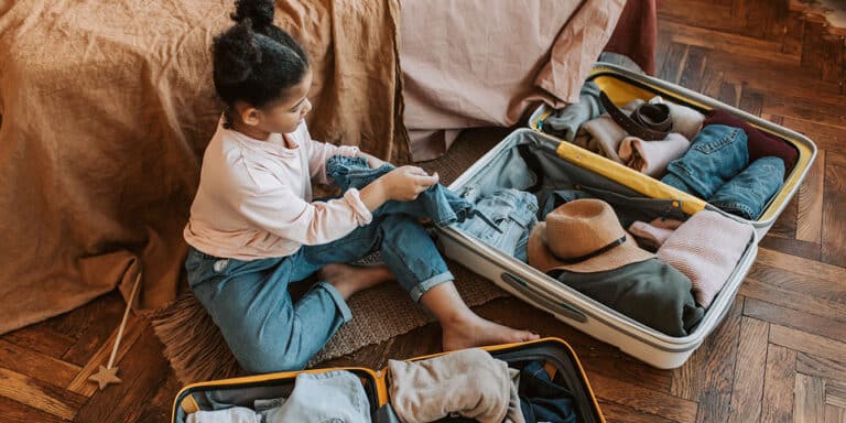 preteen packing her suitcase, helping with vacation preparation