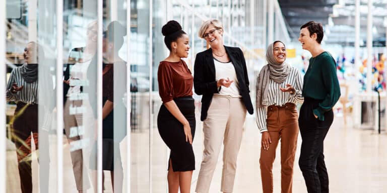 women in an office talking and displaying soft skills and interpersonal skills