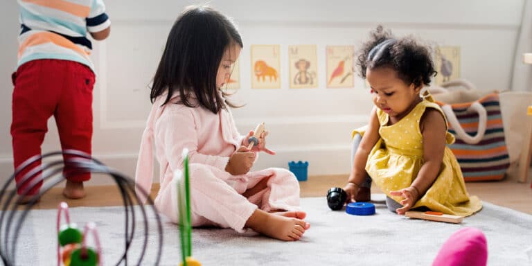 little kids playing toys in the playroom-daycare does not cause behavior problems