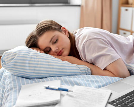 teenager taking a nap from doing homework