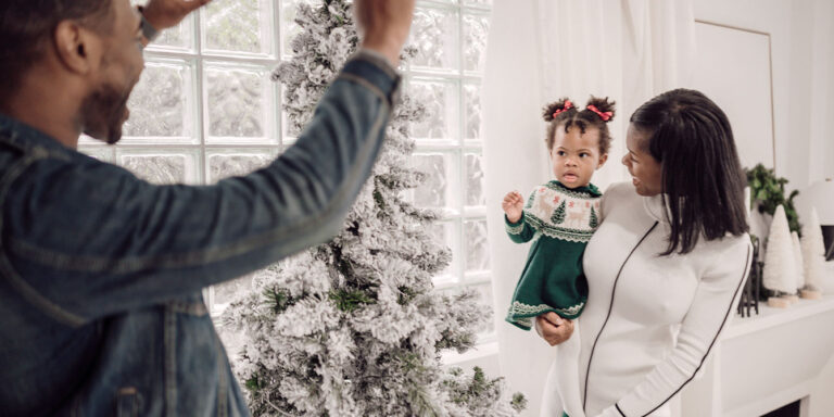 mom and toddler posing for Christmas family photos