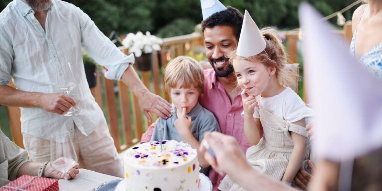 multigenerational family having a backyard birthday party