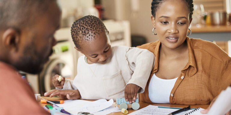 parents at the dining table looking at papers-filing 2023 taxes