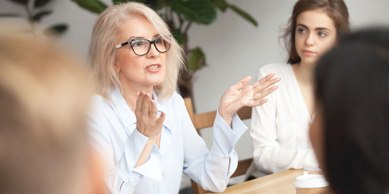 business woman talking in a meeting about support for working moms