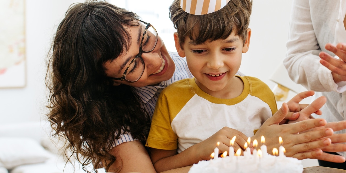 mother smiling with son celebrating his birthday party without goodie bags