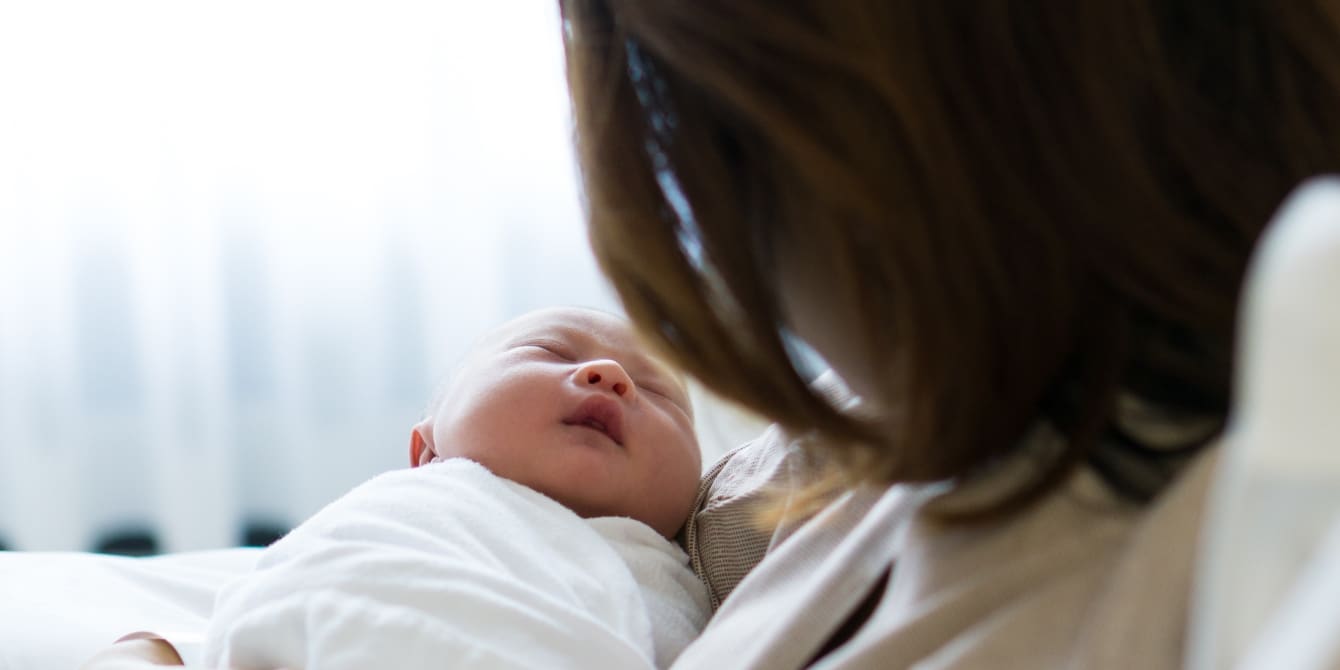 mother looking at baby's face - congenital cataracts