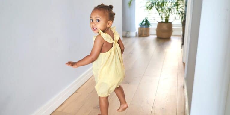 young toddler walking down hall - activities for 18-month-old