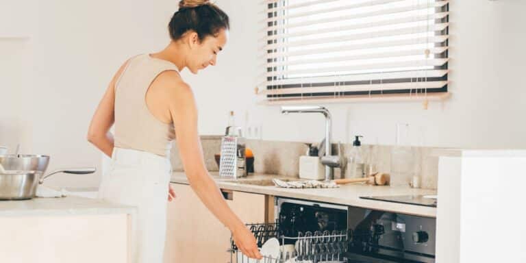 woman loading a dishwasher