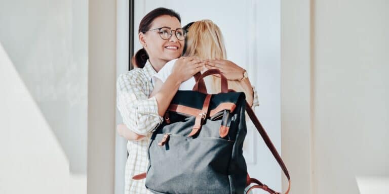 mom hugging daughter going to college - child leaves home