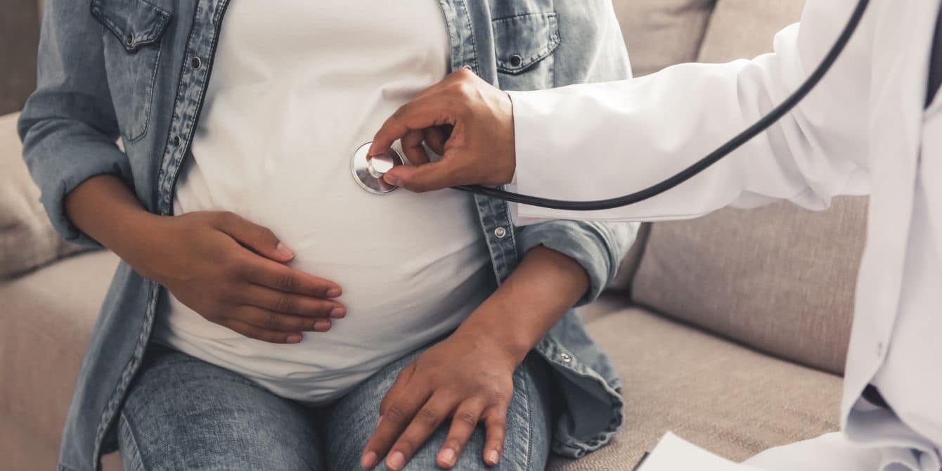 pregnant woman at doctors office checkup - RSV vaccine in pregnancy