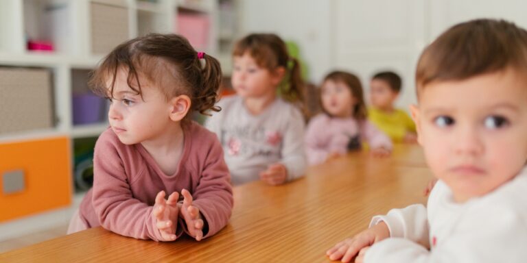 group of children at table in daycare - questions to ask a daycare provider