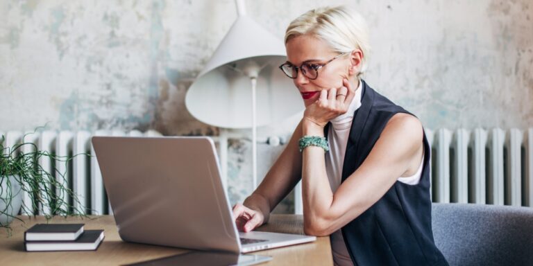 woman in her 40s working at computer - menopause at work