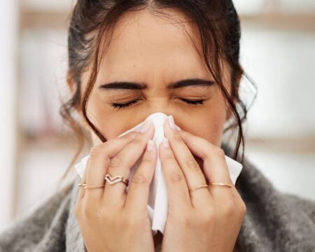 woman blowing her nose in tissue Motherly