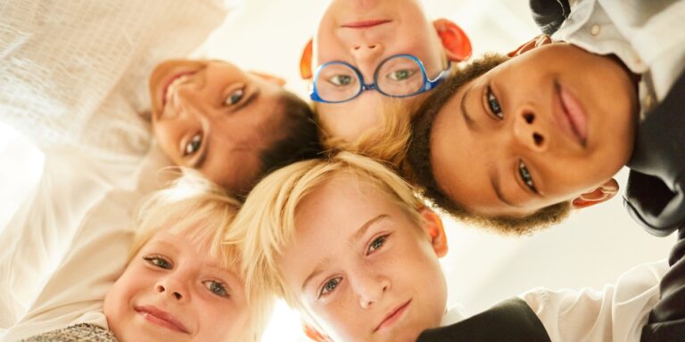 group of smiling kids faces inclusivity superpower