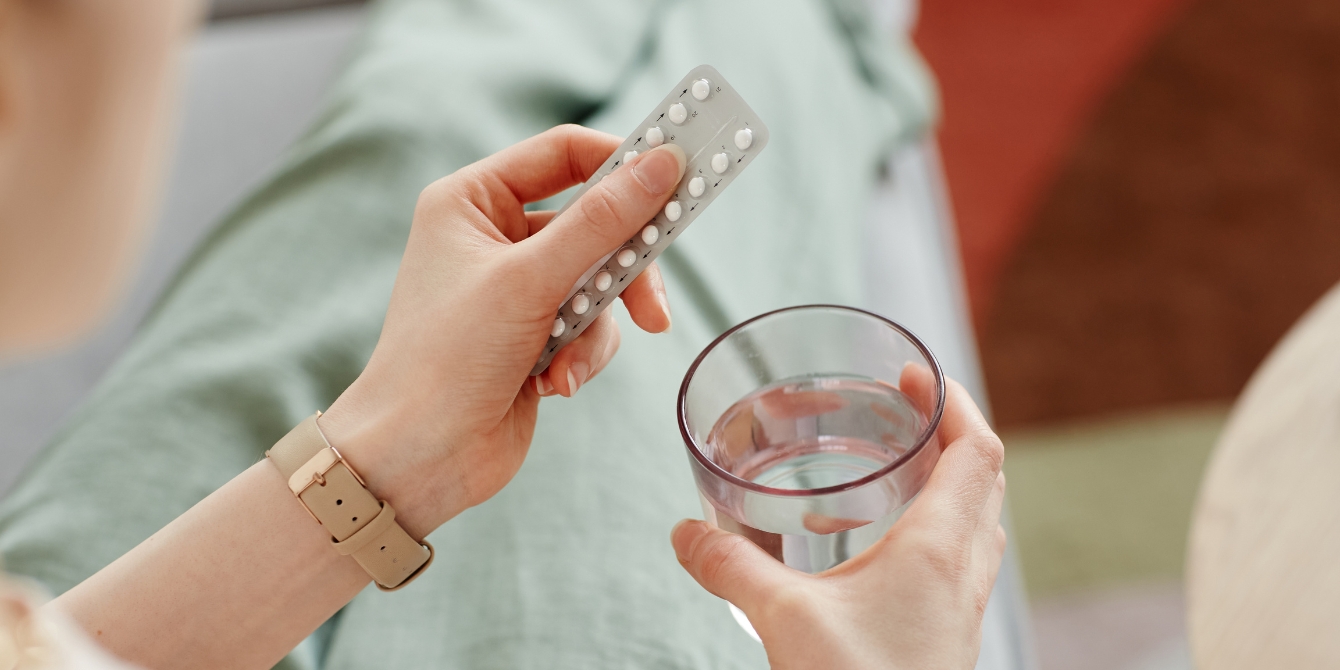 woman taking birth control pills - birth control and depression