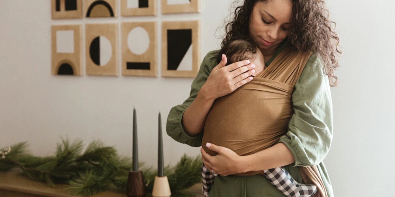 woman wearing baby in wrap reasons to babywear during the holidays