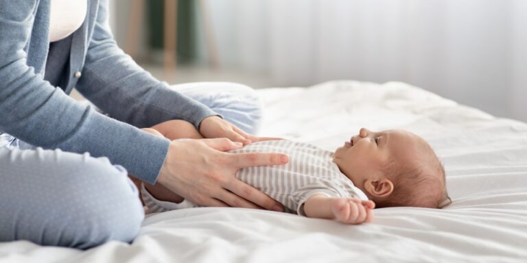 mom giving baby stomach massage infant massage mental health benefits for mom