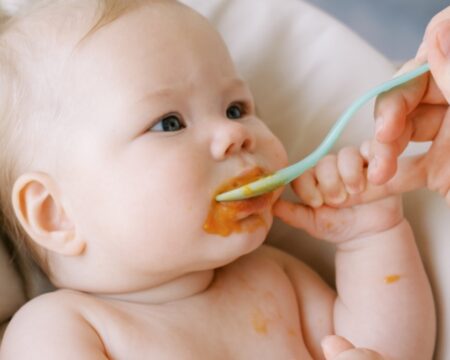 https://www.mother.ly/wp-content/uploads/2023/12/spoon-feeding-a-baby-450x360.jpeg