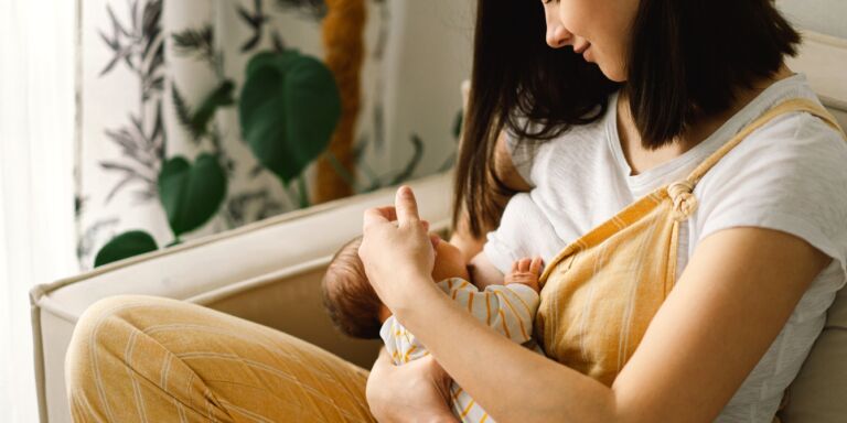 woman breastfeeding baby better sleep