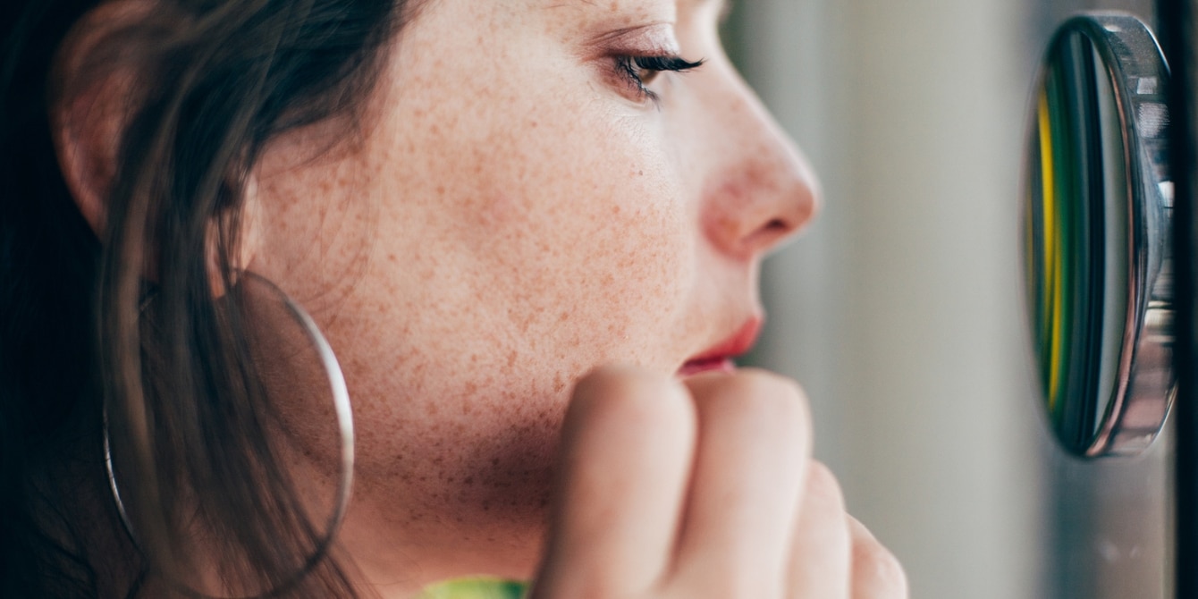 worried woman looking in mirror neurologically complex children neurodiversity autism