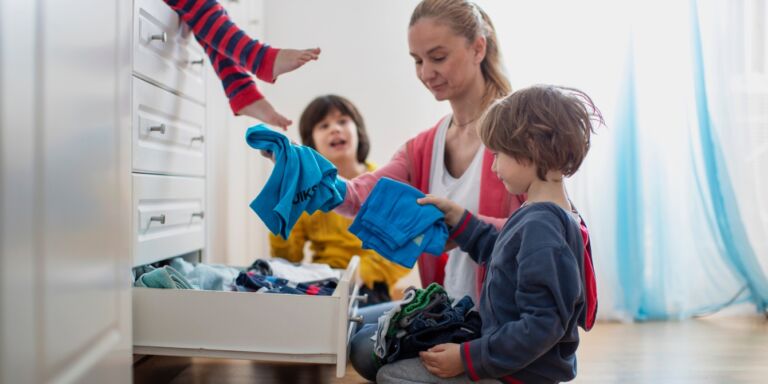 housework is never ending- mom and kids putting clothes away