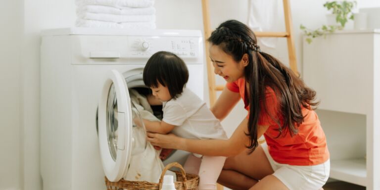 mother and toddler doing laundry viral laundry folding hack