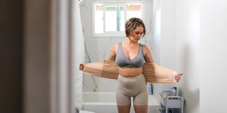 Mother Wraps Her Stomach With A Belly Band Post Pregnancy