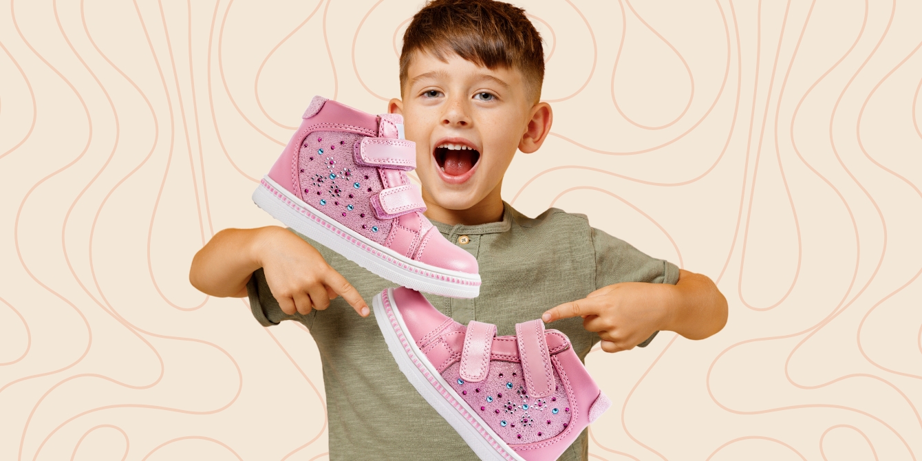 boy pointing to pink shoes