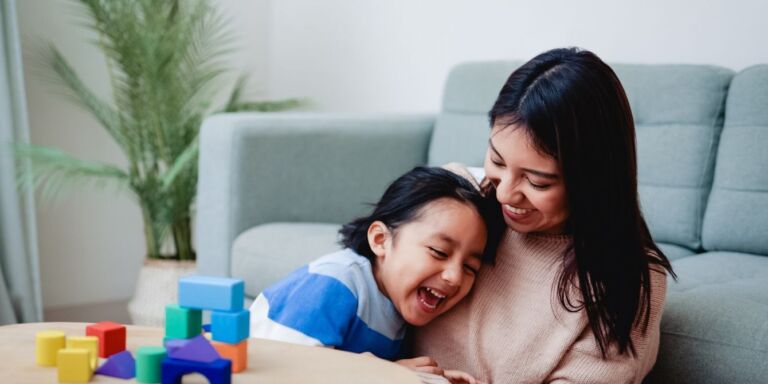 mom playing blocks with child starting montessori at home