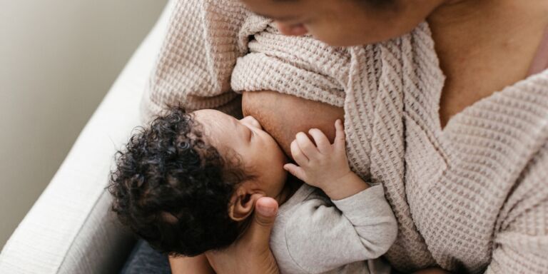 mother breastfeeding her infant son Motherly