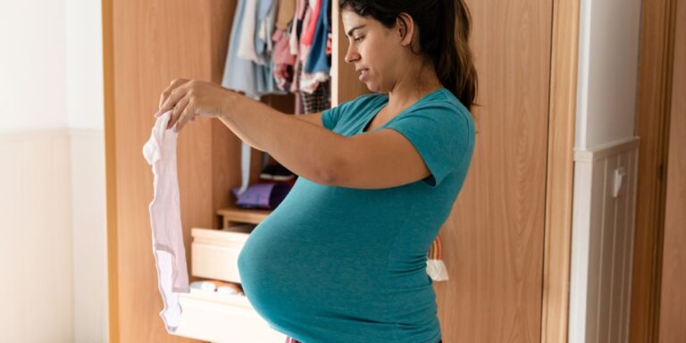 i stopped folding laundry- pregnant mom folding clothes