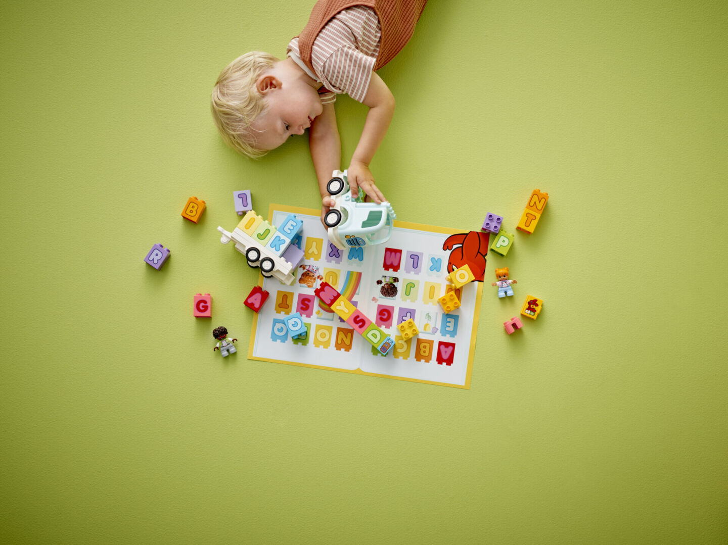 Toddler playing with LEGO DUPLO alphabet truck set