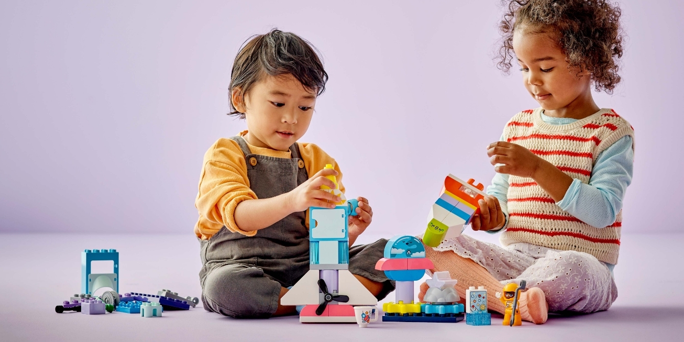 toddlers playing collaboratively with LEGO DUPLO set - collaborative play