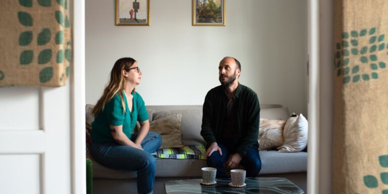 couple talking and sitting on couch - how to listen