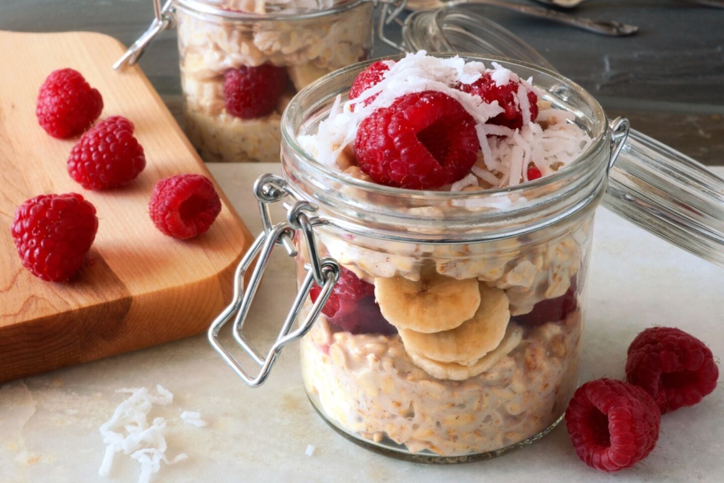 overnight oats raspberries in glass jars Motherly