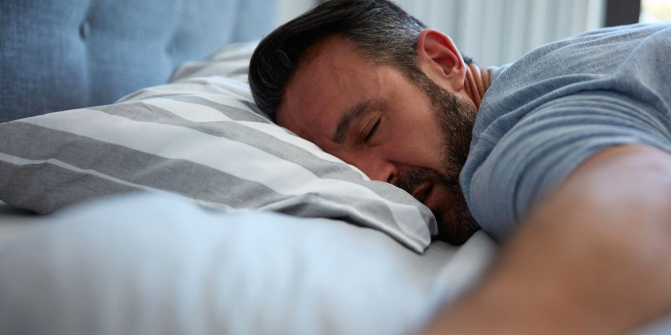 Man sleeping in bed alone