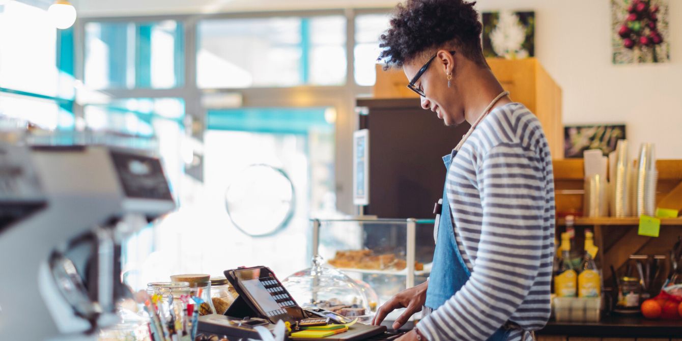 Teen working as a coffee shop cashier