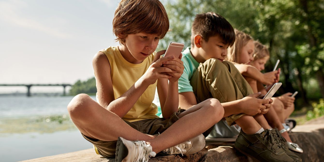 children looking at their phones