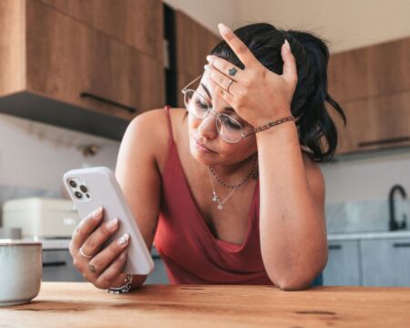 woman sad on phone Motherly