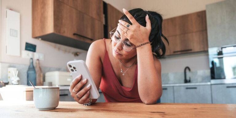 woman sad on phone Motherly