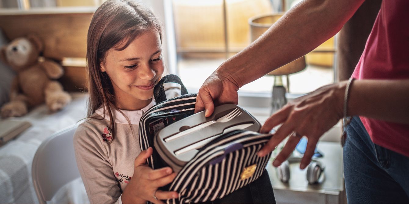 mom packing kids lunch in backpack - non-sandwich lunch ideas for kids