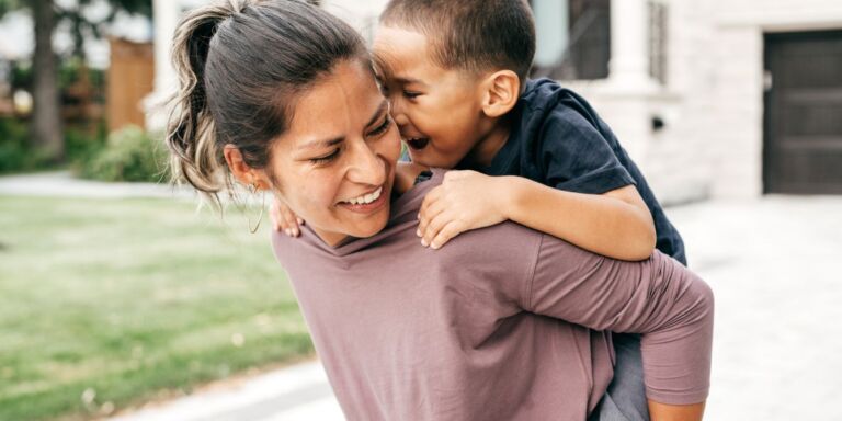 mom giving child a piggy-back ride - emotional courage