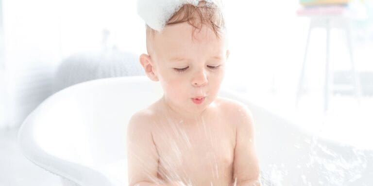 Kid getting shampooed in bath