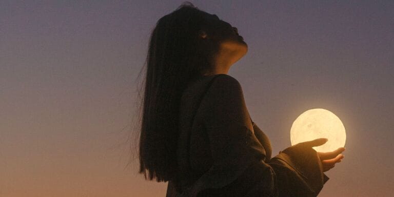 woman holding the moon - howling at the moon motherhood essay