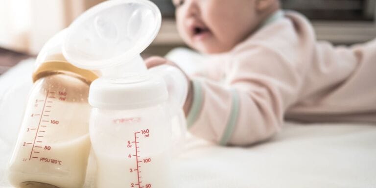 baby next to pumped breast milk - donating breast milk