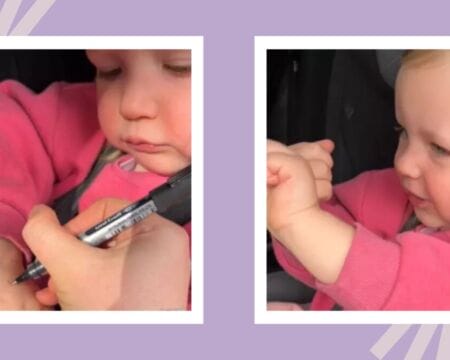 mom writing on toddlers hand Motherly